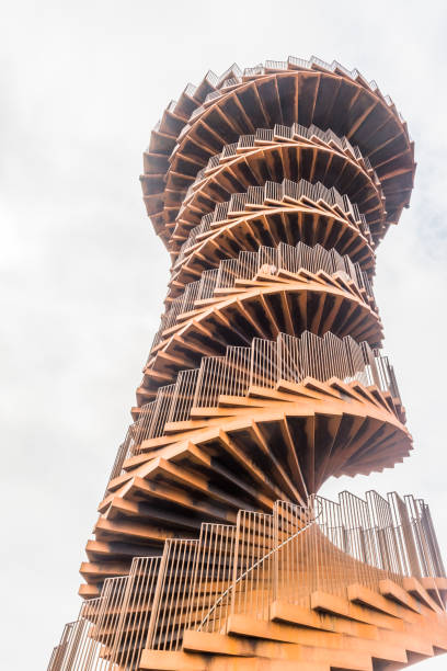Skaerbaek, Denmark - June 4, 2023: Marsk or Marsh Tower is a double helix-shaped corten steel observation tower located in the Wadden Sea National Park at Skaerbaek, Denmark. View from below.