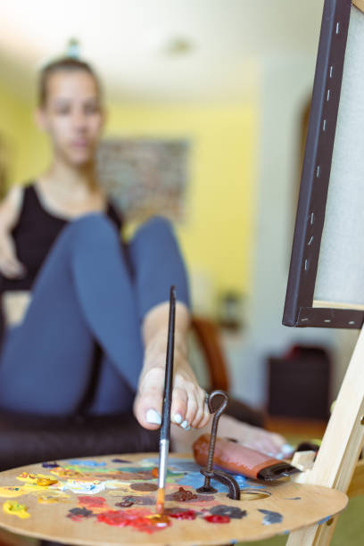 istock Embracing Diversity: Talented Disabled Artist Unveiling her Masterpiece on Canvas 1498917582