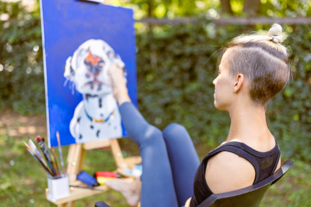 istock Embracing Diversity: Talented Disabled Artist Unveiling her Masterpiece on Canvas 1498917598