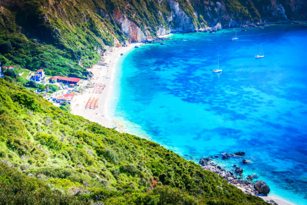 Kefalonia, Greece. Petani Beach, beautiful Greek Islands, crystal-clear water. Kefalonia, Greece. Paralia Petani, one of the most beautiful beaches of Cephalonia Island, Greek summer holiday must visit places. paralia stock pictures, royalty-free photos & images
