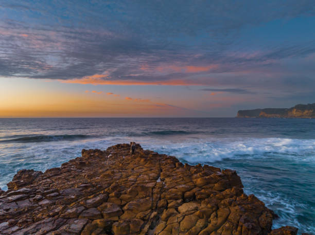 istock Ocean sunrise with rock platform and clouds 1498923816