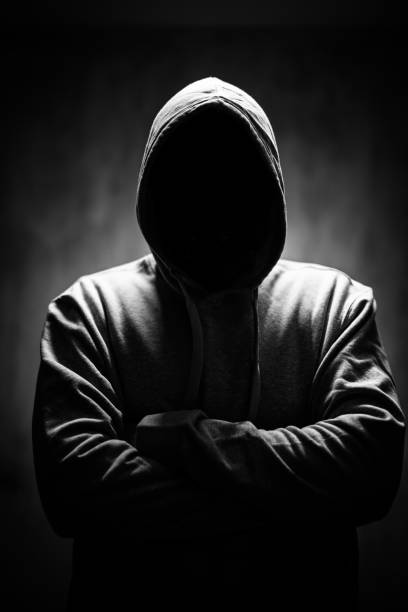 istock Scary Faceless Man In A Hoodie Under Neon Lights 1498924896