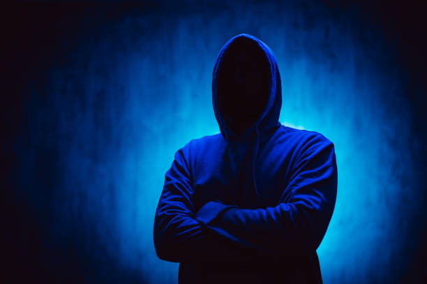 istock Scary Faceless Man In A Hoodie Under Neon Lights 1498925065