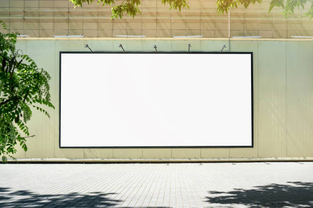 istock Big empty white billboard mounted on city mall wall outside. 1498925177