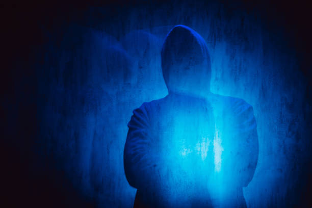 istock Scary Faceless Man In A Hoodie Under Neon Lights 1498925393