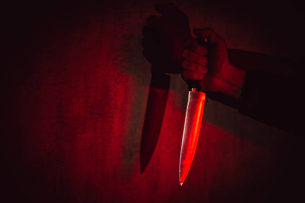 istock Man Holding A Knife Under Neon Lights 1498925641
