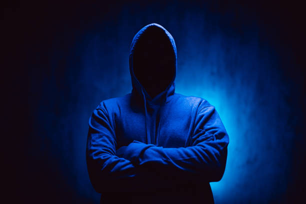 istock Scary Faceless Man In A Hoodie Under Neon Lights 1498925689