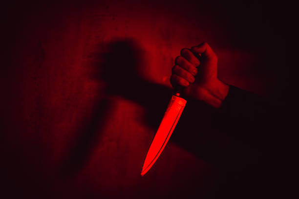 istock Man Holding A Knife Under Neon Lights 1498925745