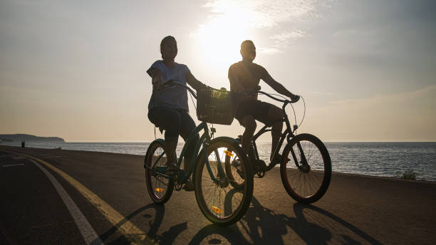 istock Couple taking pleasure in the ride on beach cruiser bikes 1498926319