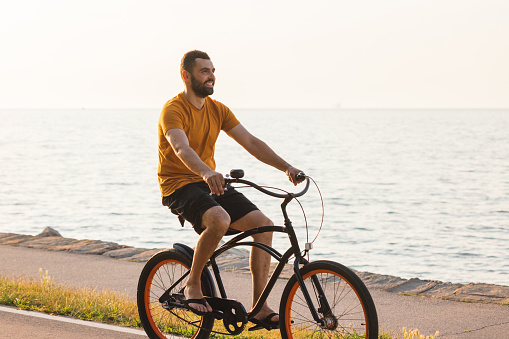 Young businessman driving a bicycle in the morning