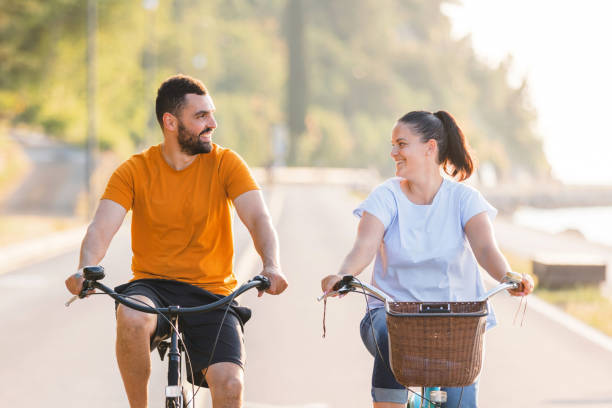 Couple enjoying a cycle ride along the seacoast