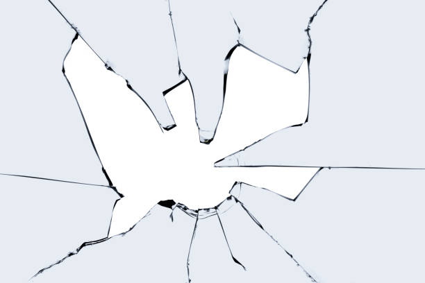 istock A broken window with cracks and pieces of sharp glass. Cracked texture for design. 1498928669