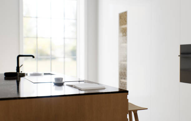 istock The interior of a light minimalist kitchen-studio with a wooden island. Kitchen with bar stool and black marble top with large window and appliances. Black faucet and stove on the island. 3D rendering 1498930448
