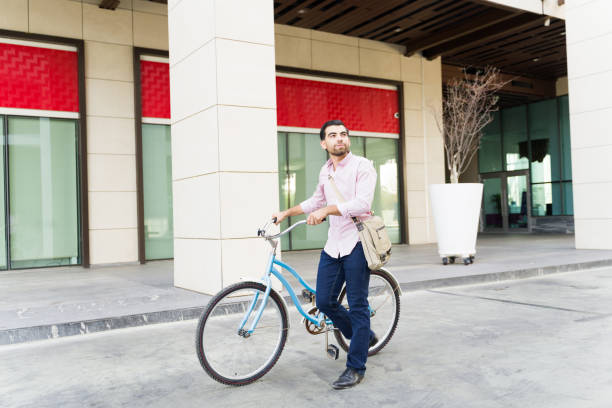 istock Casual business man using his bicycle and commuting to work 1498930511