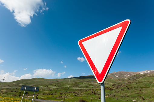 Road sign warning that the road is not the main day