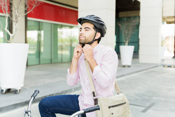 istock Hispanic man putting on a helmet preparing for his bike ride 1498930875