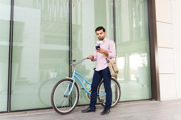 istock Latin young man using his phone before his commute in the city 1498931087