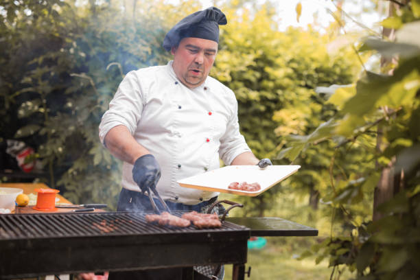 istock Chef placing meat on a barbecue 1498932026