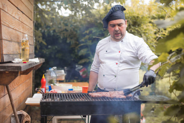 istock Chef checking meat on grill with chef's tweezers 1498932585