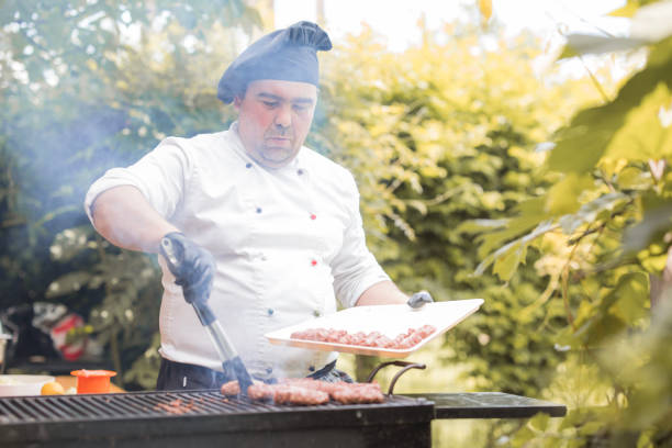 istock Chef placing meat on a barbecue 1498932589