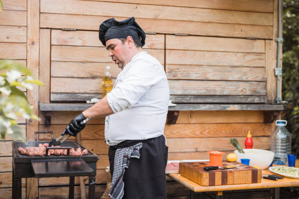 istock Chef preparing ground beef on a grill outdoors 1498933311