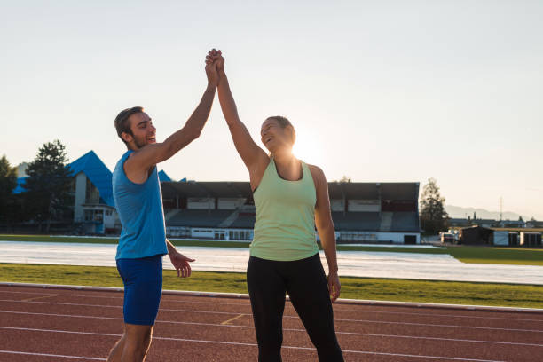 istock Young sport couple training on athletic stadium 1498937160