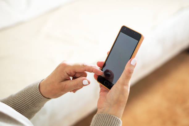istock Close up of hands from a woman using her mobile phone. 1498937637