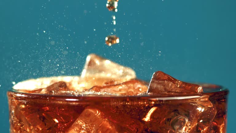 Cola drink in a glass with bubbles in the air.