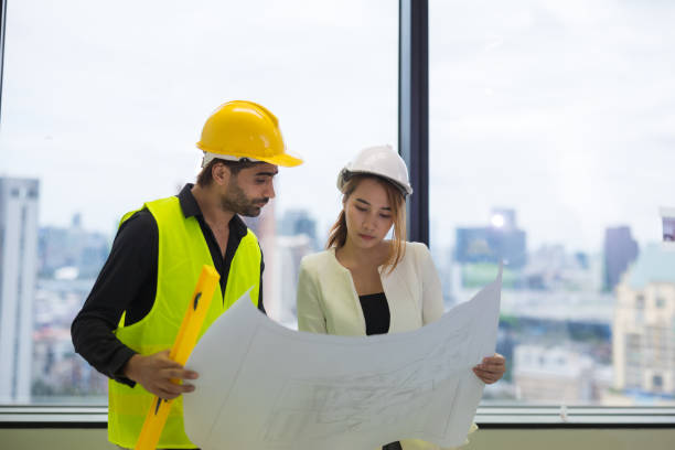istock A male Middle East engineer consulting with female architecture with construction plan inside the building. 1498937837