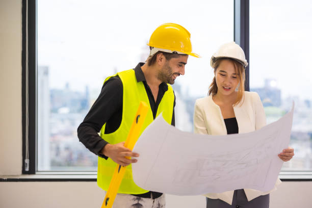istock A male Middle East engineer consulting with female architecture with construction plan inside the building. 1498937911