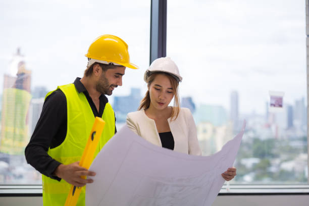 istock A male Middle East engineer consulting with female architecture with construction plan inside the building. 1498937976