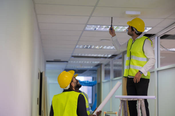 istock Group of engineering fixing the ceiling in building by climbing the ladder. 1498938117