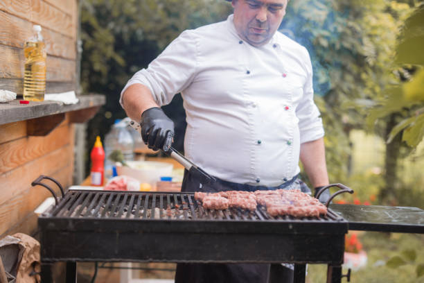 istock Cook using meat tweezers when grilling meat 1498939553