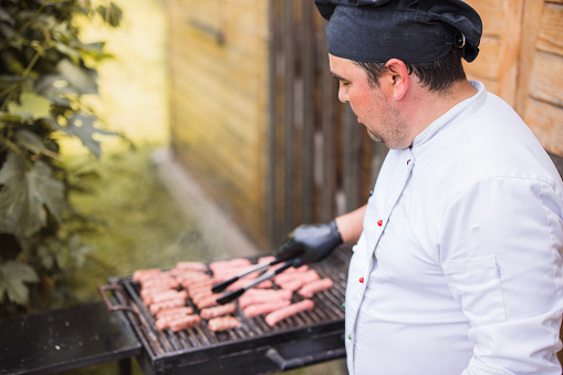 Man working on a barbecue grill