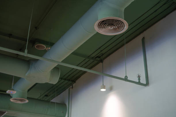 istock Air ventilation system. Air conditioner pipe. Ventilation duct. Air flow and ventilation system inside building. HVAC duct. Air conditioning duct installation on ceiling wall. Ductwork inside building 1498943706