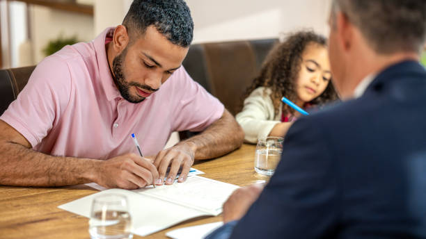istock Man with daughter signing leasing agreement 1498944283
