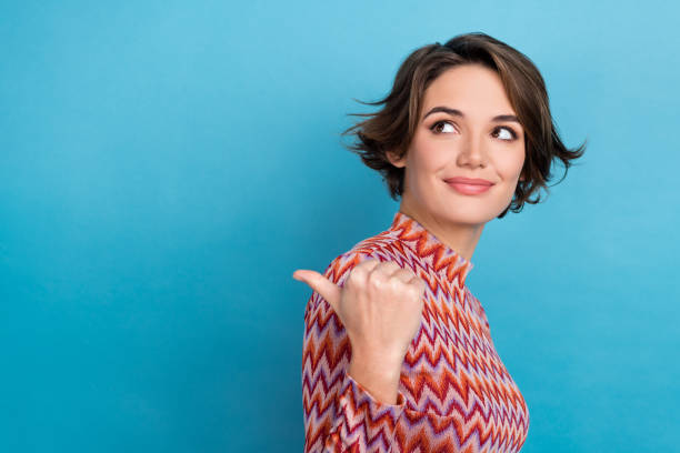 Closeup photo lady indicate finger empty space mockup billboard interesting news wear print shirt isolated blue color background stock photo