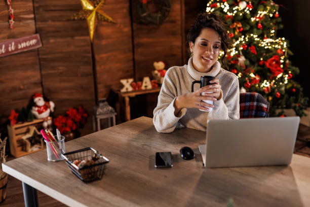 istock Young woman on a coffee break and using laptop at her desk 1498947027