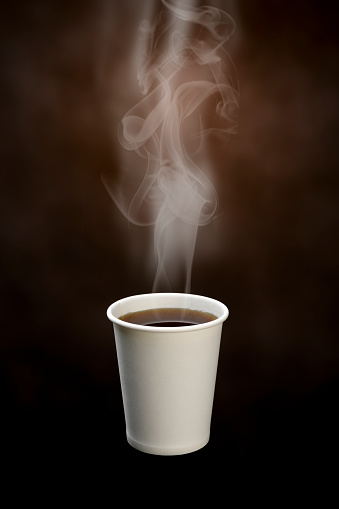 Close-up of a smoking disposable coffee cup