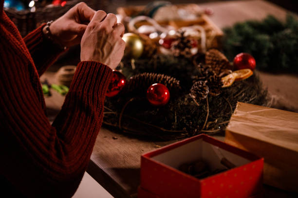 istock Creative young man in a red sweater decorating a Christmas wreath 1498950204