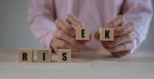 istock Risk and Rise text on wooden block. risk concept idea. man hand choosing block 1498950453