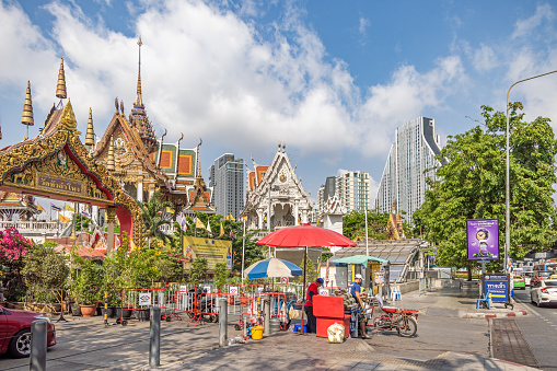 Wat Hua Lamphong, Bangkok, Thailand - March 23th 2023: Typical skyline with a old temple and modern high-rise buildings in the center of the Thai capital