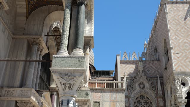 Architectural elements of Basilica San Marco and Doge's Palace against a bright blue sky, Venice, Italy.