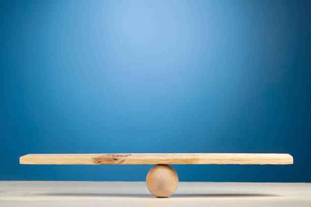 istock Stability, balance and equality concept. Wooden scale on blue background. 1498954303