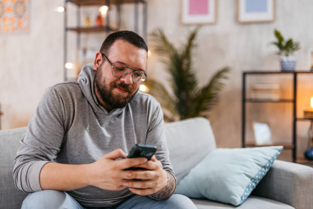 istock Young Man Using His Phone And Enjoying His Private Time. 1498955490