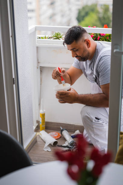 istock Handyman mixing color before repainting balcony walls 1498958528