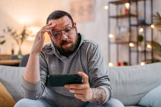 istock Young Man Watching Content On His Phone 1498958779