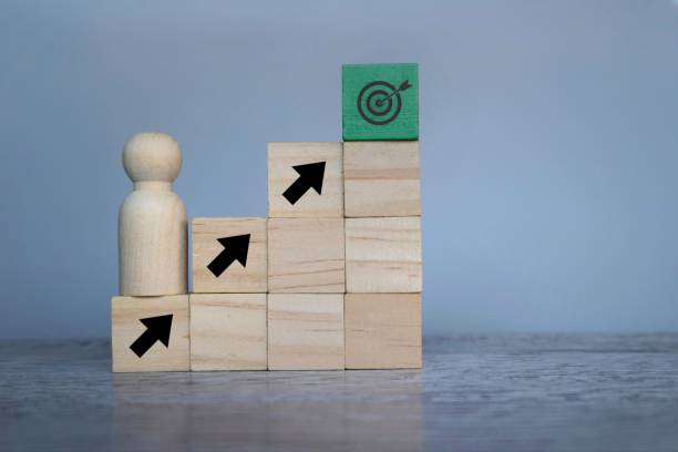 istock Wooden doll with upward arrows and target board. 1498958929