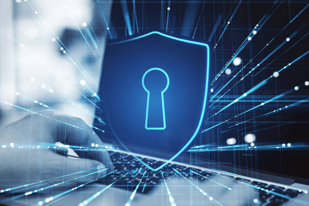 istock Close up of hands using laptop with abstract glowing shield and digital blue mesh hologram on blurry background. Safety and secure concept. Double exposure. 1498958966
