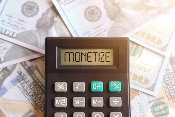 istock Top view image of calculator with text MONETIZE on display and money 1498958989